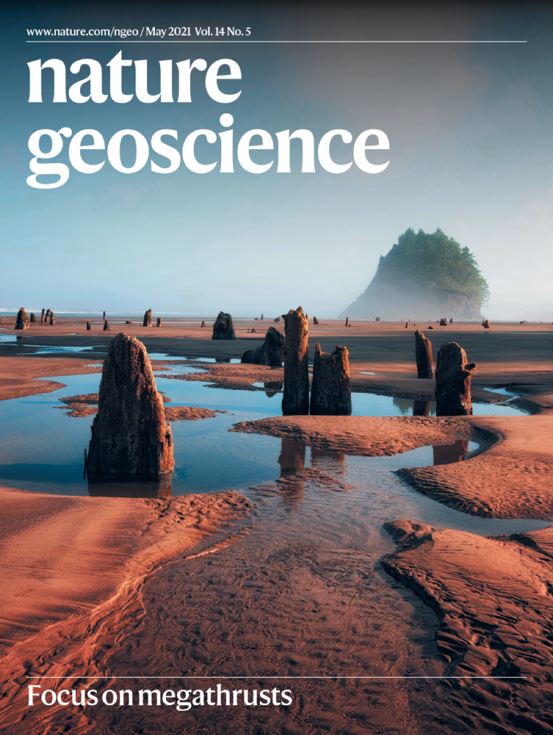 Cover of Nature Geoscience featuring a photo of a sandy landscape with pools of water and stumps protruding from the ground.